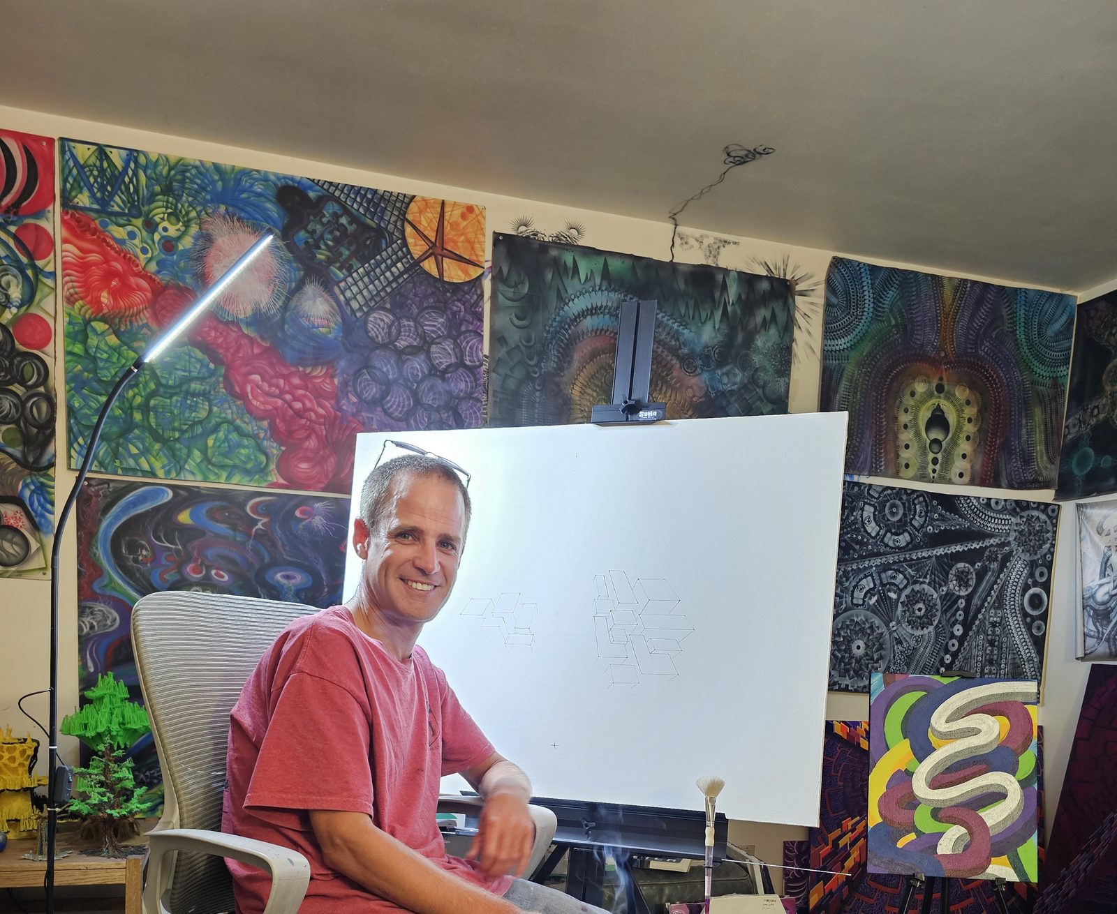 Gus Bradt in his studio surrounded by original paintings